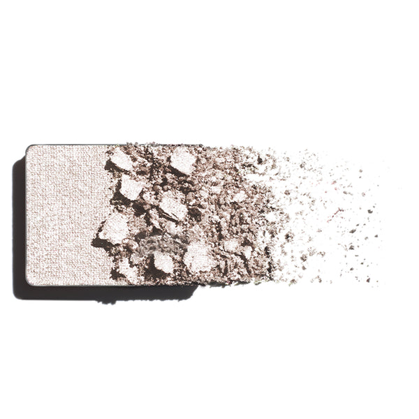 Makeup eyeshadow refill with champagne powder on a white background