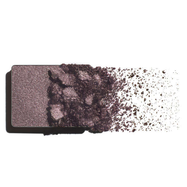 Makeup eyeshadow refill with taupe-amethyst powder on a white background