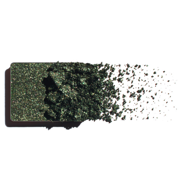 Makeup eyeshadow refill with rich emerald shimmer powder on a white background