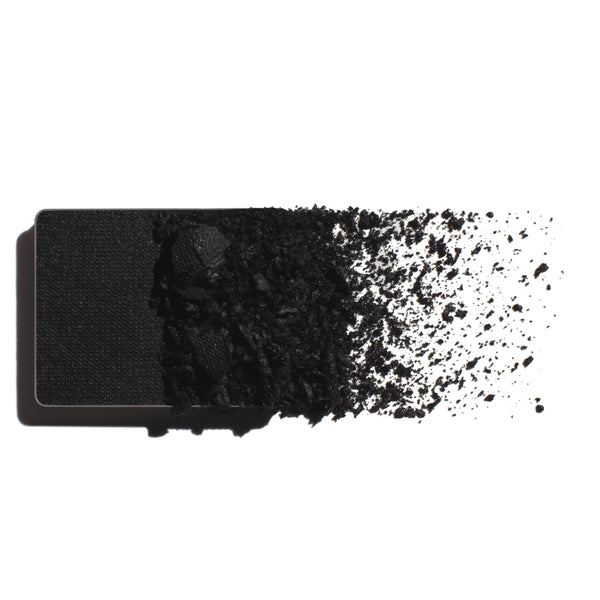 Makeup eyeshadow refill with true black powder on a white background
