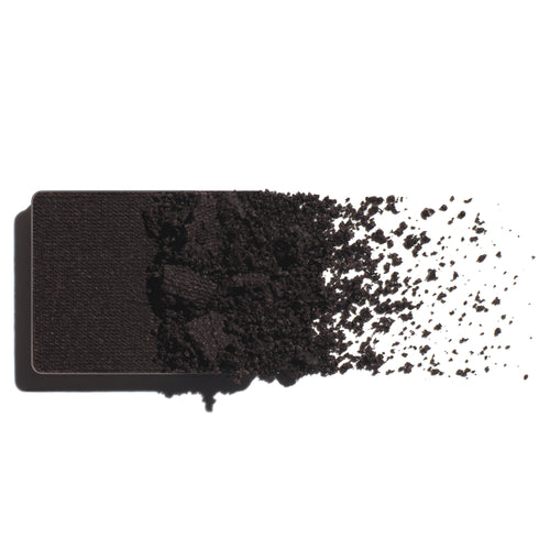 Makeup eyeshadow refill with dark violet powder on a white background