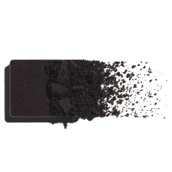 Makeup eyeshadow refill with dark violet powder on a white background