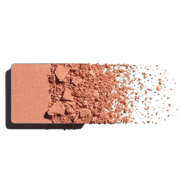 Makeup eyeshadow refill with soft apricot powder on a white background
