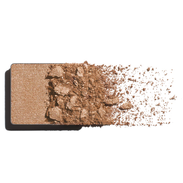 Makeup eyeshadow refill with pearled champagne powder on a white background