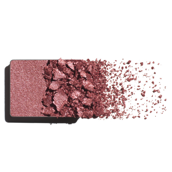 Makeup eyeshadow refill with warm rose powder on a white background