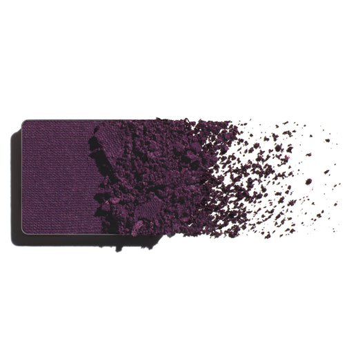 Makeup eyeshadow refill with pure violet powder on a white background