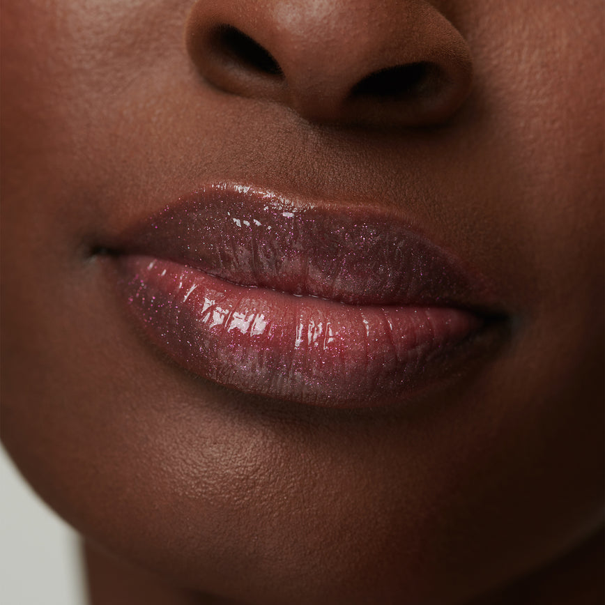 model wearing Gloss Embrace Lip Gloss in shade Dancing Rose
