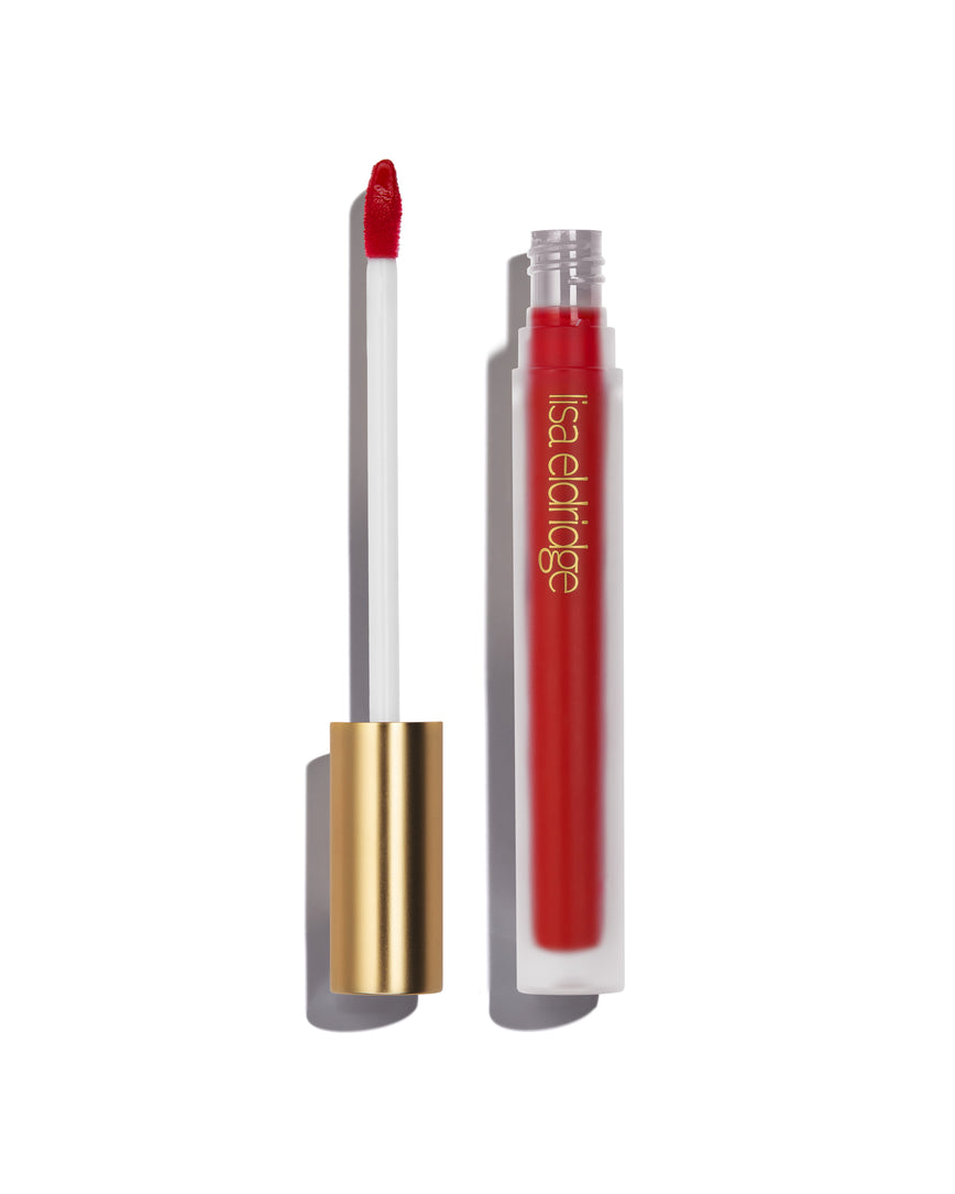 Pillar-box red Ribbon Velveteen Liquid Lip Colour with open gold cap, frosted bottle on a white background, with lisa eldridge branding featuring a CEW Beauty Award Winner 2024 badge.
