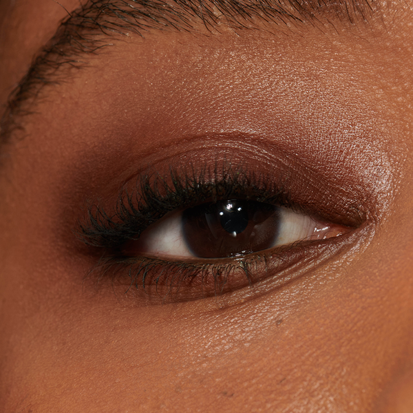 Close-up of a model's eye with Ground Coffee Seamless Glide Eye Pencil