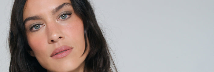 Close-up of Alexa Chung with Lisa Eldridge makeup on, on a neutral banner