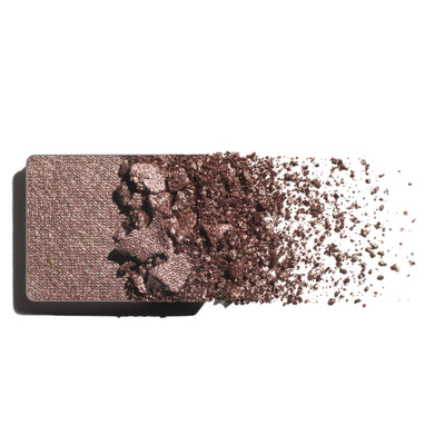 Makeup eyeshadow refill with mushroom-y shimmer powder on a white background