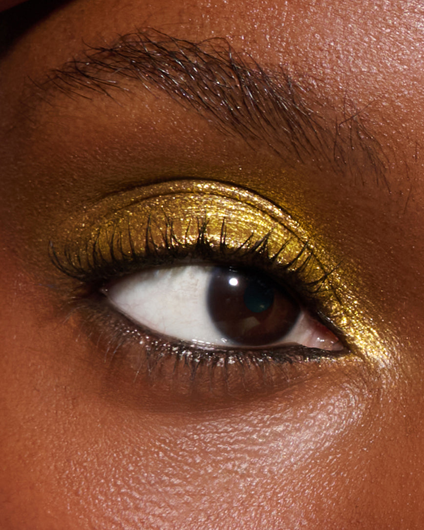 Extreme close-up of an eye with  yellow-gold eyeshadow from Desert Gleam Eyeshadow Palette