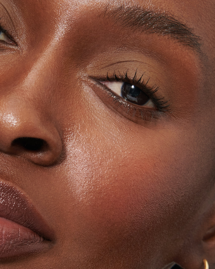 Extreme close-up of model's eye wearing golden brown Gaia Liquid Silk eyeshadow