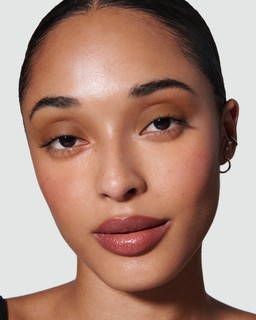 Portrait close-up of model wearing golden brown Gaia Liquid Silk eyeshadow
