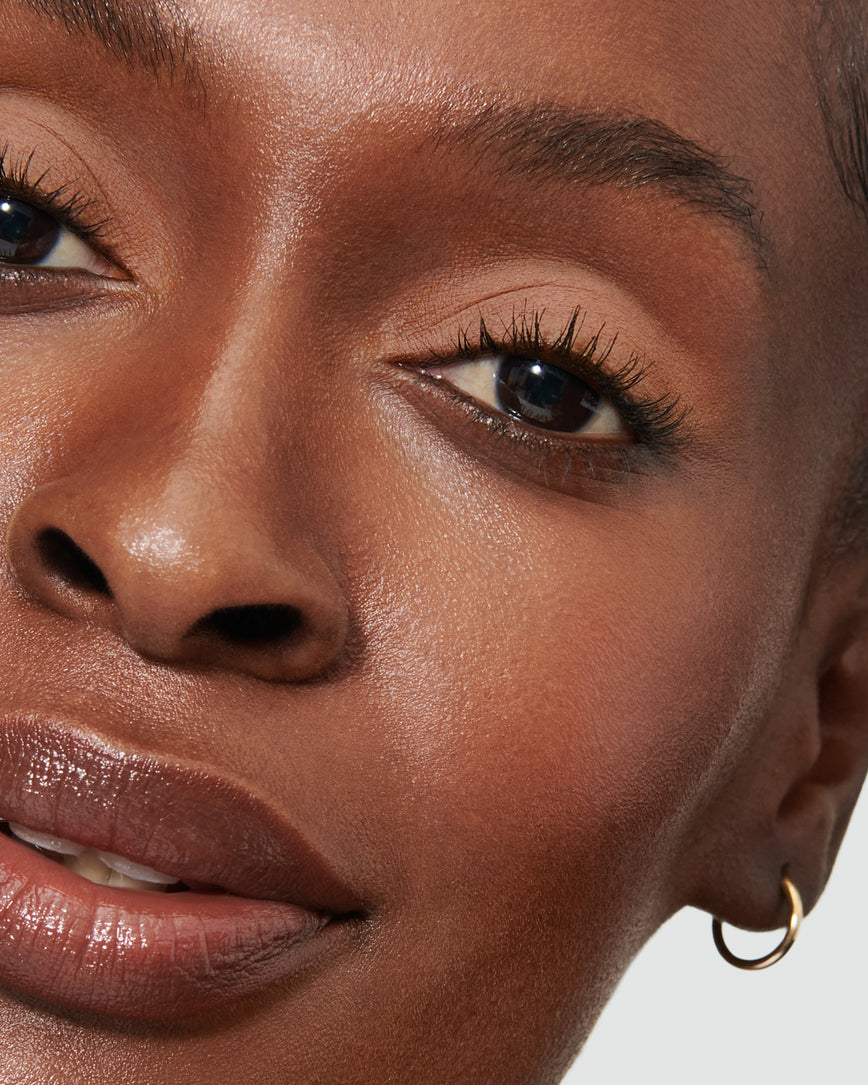 Extreme close-up of model's eye wearing peachy beige Irene Liquid Silk eyeshadow