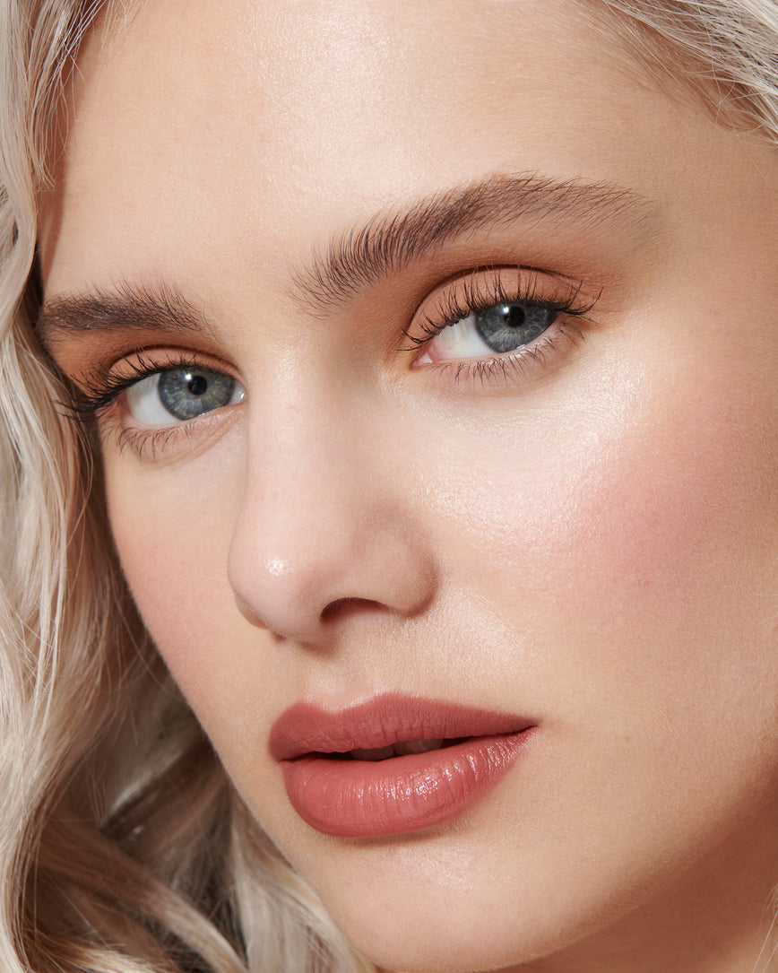Portrait close-up of model wearing peachy beige Irene Liquid Silk eyeshadow