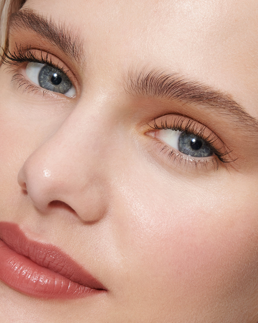 Portrait close-up of model wearing peachy beige Liquid Silk eyeshadow in Irene