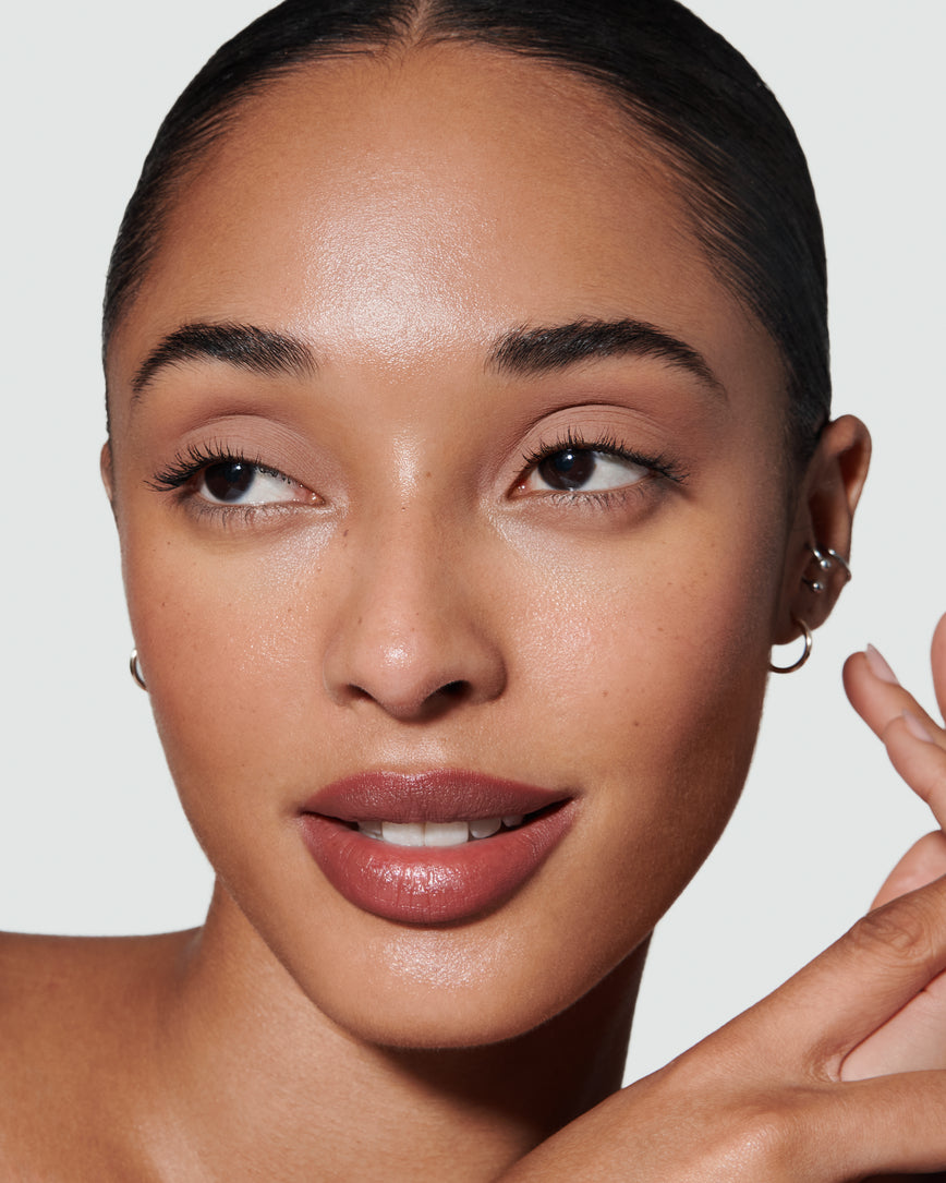 primary_meta_image Portrait close-up of model wearing peachy beige Irene Liquid Silk eyeshadow