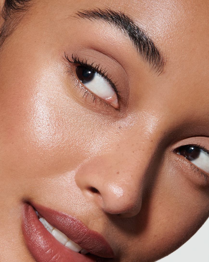 Portrait close-up of model wearing peachy beige Irene Liquid Silk eyeshadow