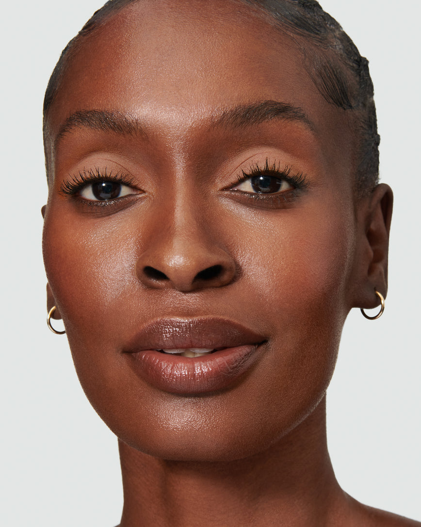 Portrait close-up of model wearing peachy beige Irene Liquid Silk eyeshadow