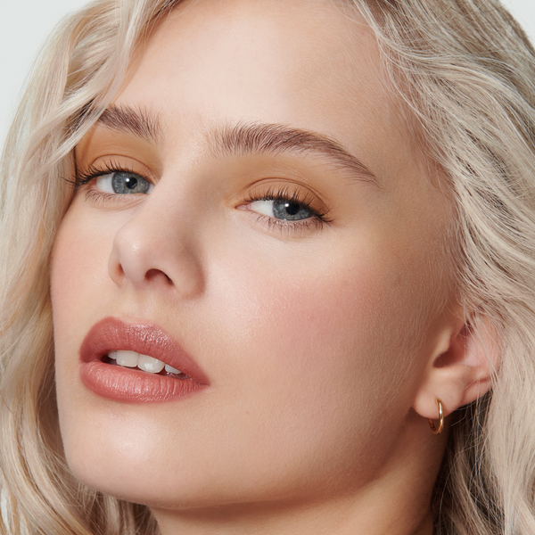 Close-up of a model's face with Phoebe Liquid Silk Eyeshadow, Epanoui and Seamless Skin Enhancing Tint