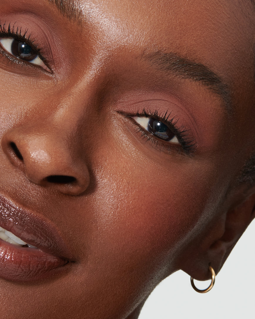 Extreme close-up of model's eye wearing deep rosewood Thalia Liquid Silk eyeshadow