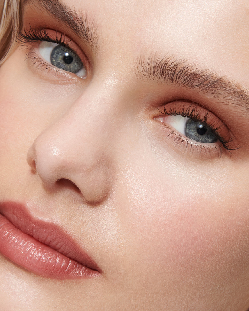 Close-up of model's eye wearing deep rosewood Thalia Liquid Silk eyeshadow