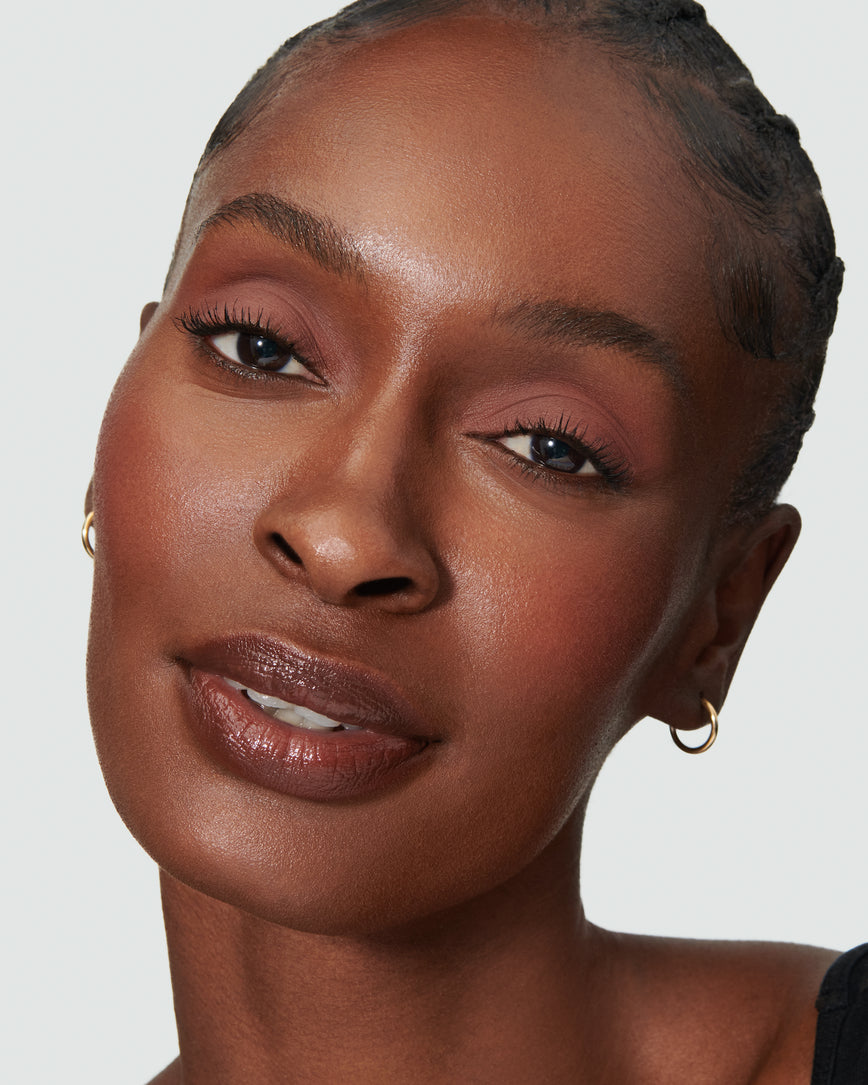 Portrait close-up of model wearing deep rosewood Thalia Liquid Silk eyeshadow