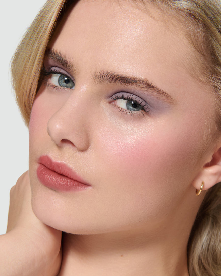 Close up of a model wearing Maude Liquid Silk Eyeshadow on a neutral background
