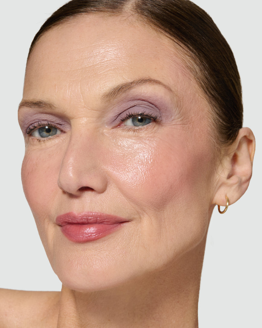 Close up of a model wearing Maude Liquid Silk Eyeshadow on a neutral background