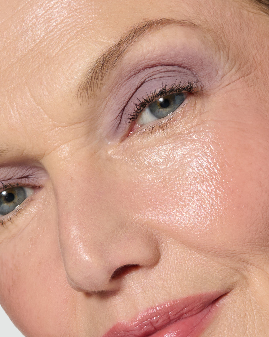 Extreme close up of a model wearing Maude Liquid Silk Eyeshadow on a neutral background
