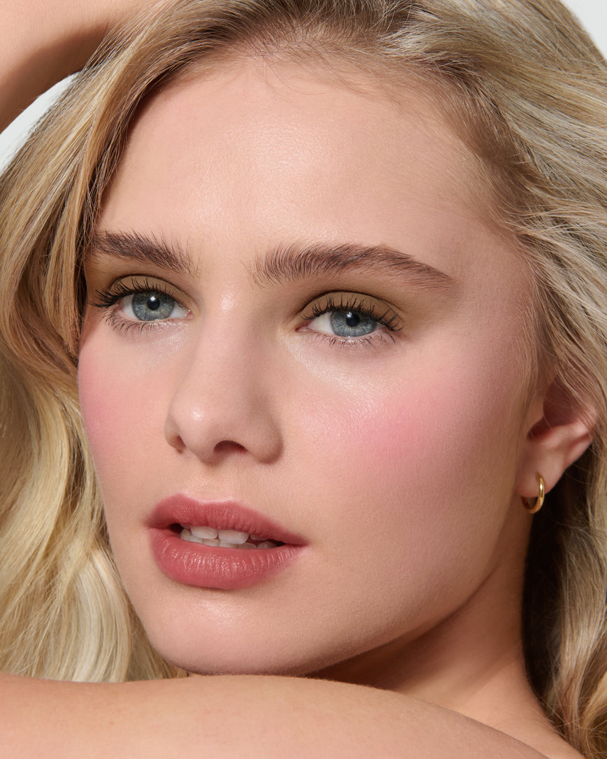 Close up of a model wearing Mimi Liquid Silk Eyeshadow on a neutral background