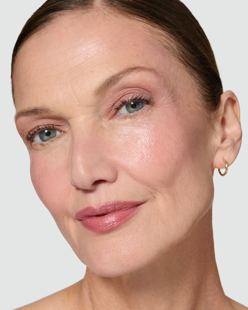 Close up of a model wearing Silvia Liquid Silk Eyeshadow on a neutral background