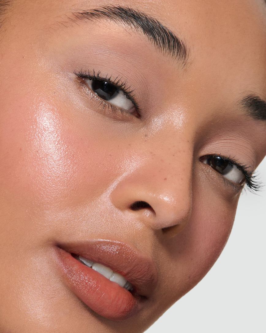 Extreme close up of a model wearing Silvia Liquid Silk Eyeshadow on a neutral background