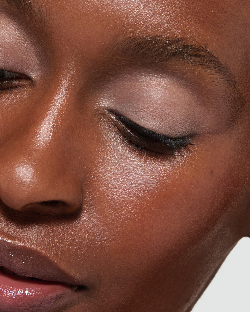 Close up of a model wearing Silvia Liquid Silk Eyeshadow on a neutral background