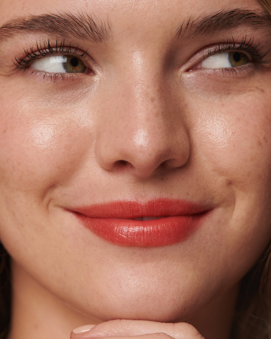 baumeimg Portrait close-up of model wearing Red Curve Baume Embrace