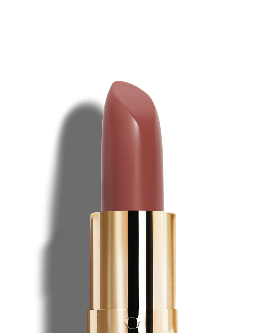Medici lipstick with gold casing on a white background