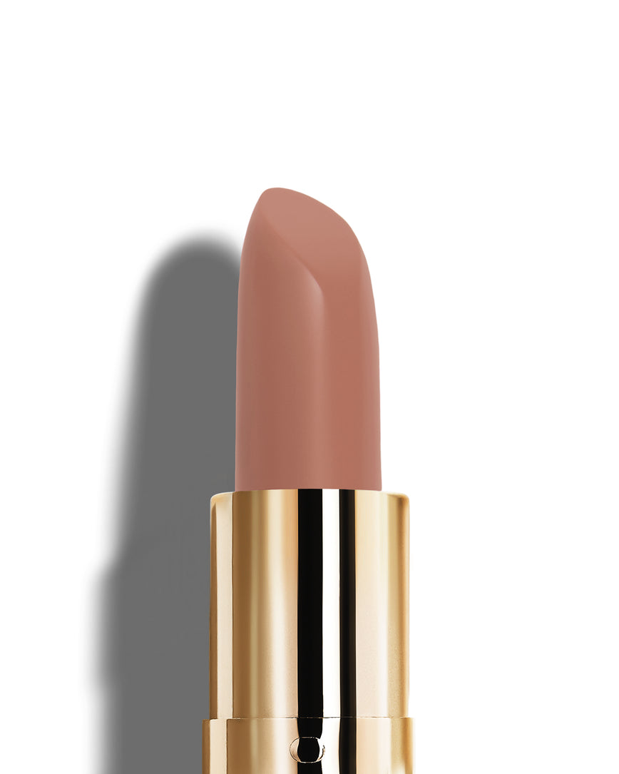 Neutral-beige lipstick with gold casing on a white background
