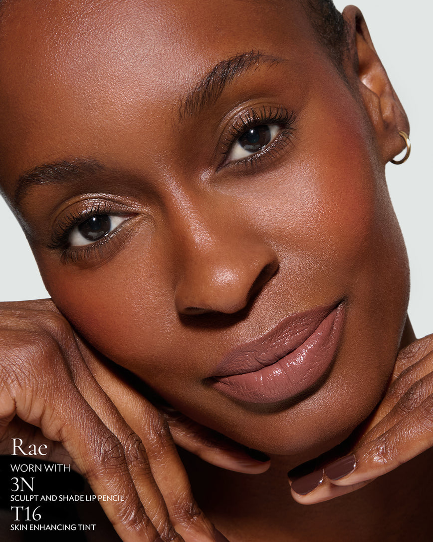 Close-up of a woman's face with makeup, featuring the new Rouge Experience Shade 'Rae', 3N Sculpt Pencil and T16 Tint