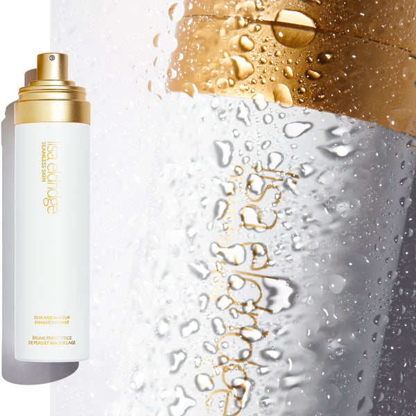 Extreme close-up, in the background, of a Seamless Skin and Makeup Enhancing Mist, with a water mist effect. With a product pack of the Mist in the foreground