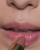 Lip extreme close up of Toasted Rouge Refillable Lipstick being applied by a model