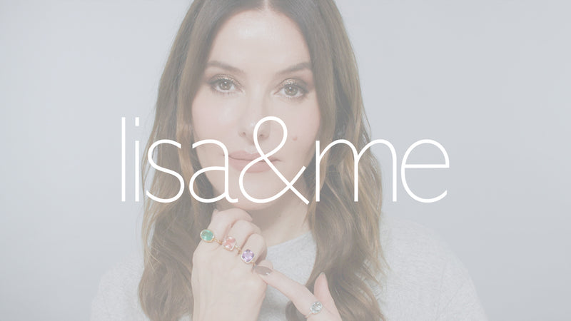 Poster image with white overlay for a video. Lisa Eldridge is in front of a grey background. Her chin rests on her hand which has three different coloured rings which she points to with her other hand. On top of the image is the text, “Lisa&me”.