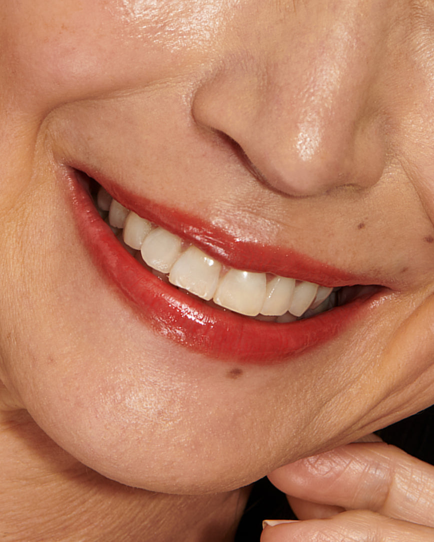 Close-up of a model's lips with Red Curve Baume Embrace