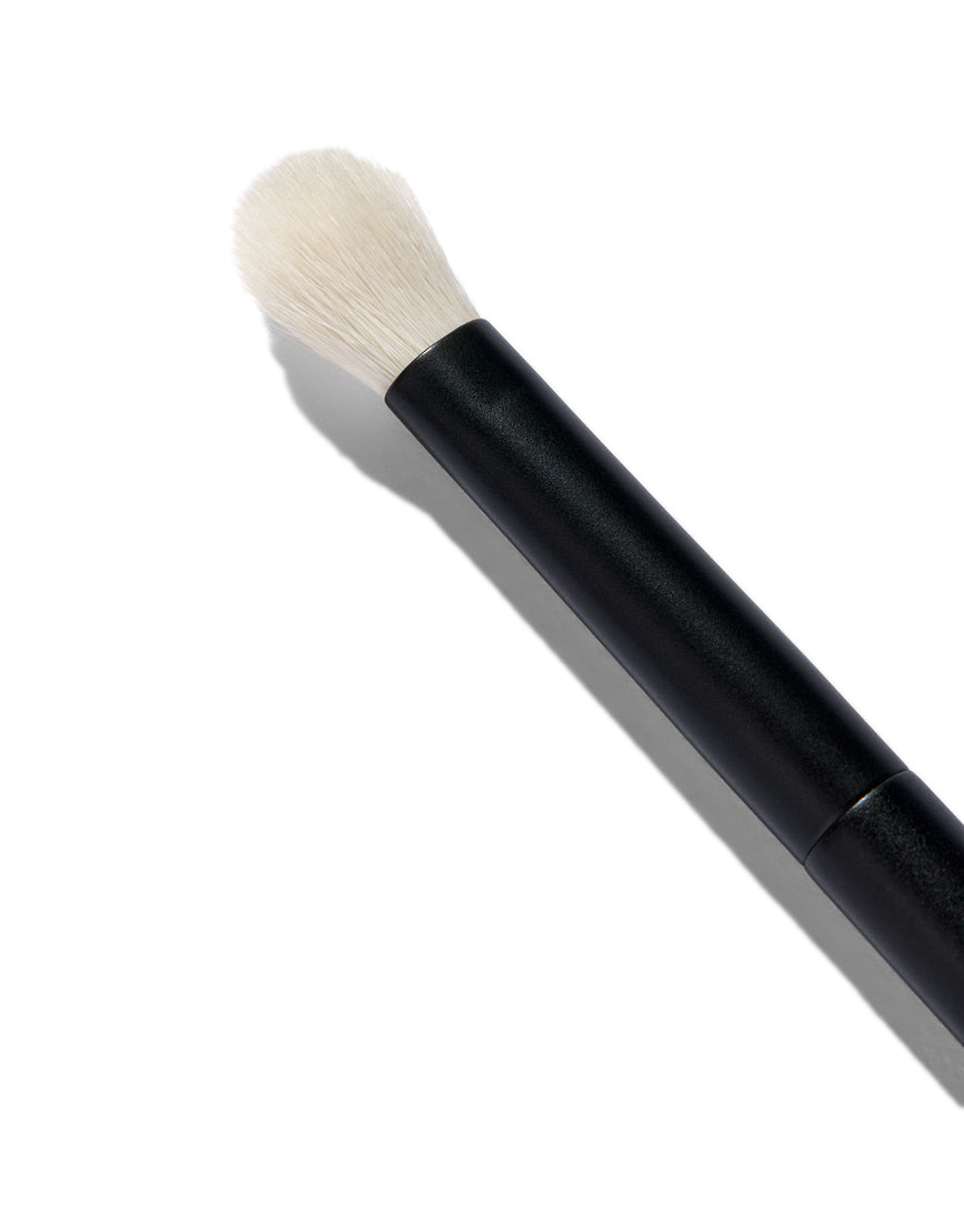 Close up of the No. 8 Seamless Blend Brush. You can see the white bristles of the brush. It has a short, round tip.