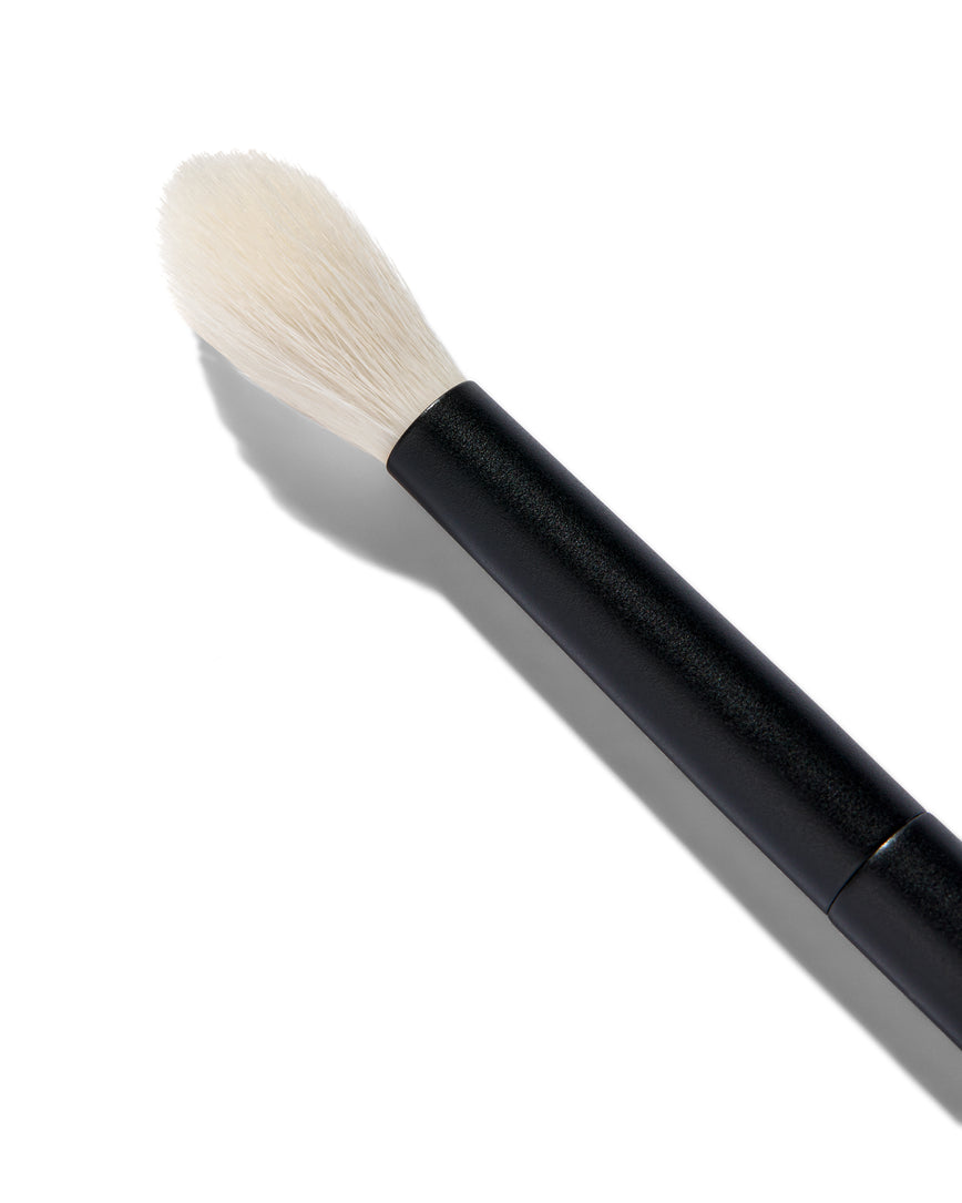 Close up of the No. 9 Seamless Blend Brush. You can see the long, tapered white bristles