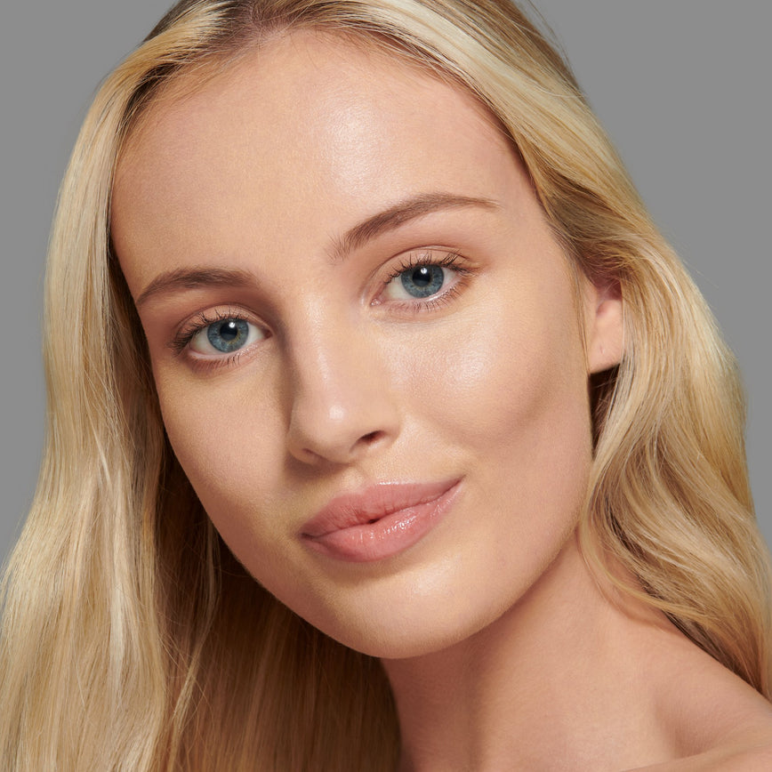 Lisa Eldridge Seamless Skin Foundation Pictured on Model. A young model with light skin and golden undertones, blue eyes and blonde straight hair.