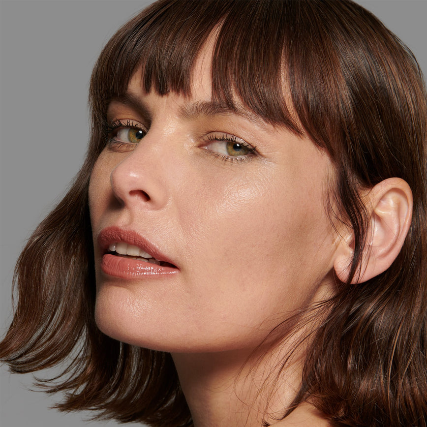 Lisa Eldridge Seamless Skin Foundation Pictured on Model. The model has light/medium skin and neutral undertones, green eyes and slightly wavy chestnut hair.