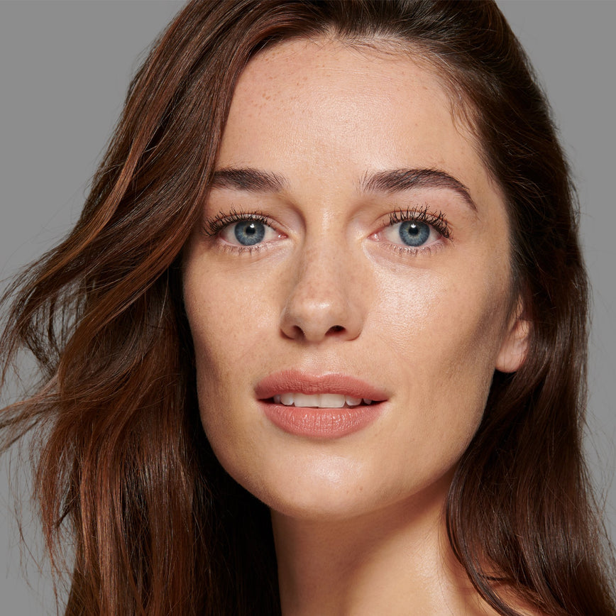 Lisa Eldridge Seamless Skin Foundation Pictured on Model. The model has light/medium skin and neutral rosy undertones, blue eyes and slightly wavy brown hair.