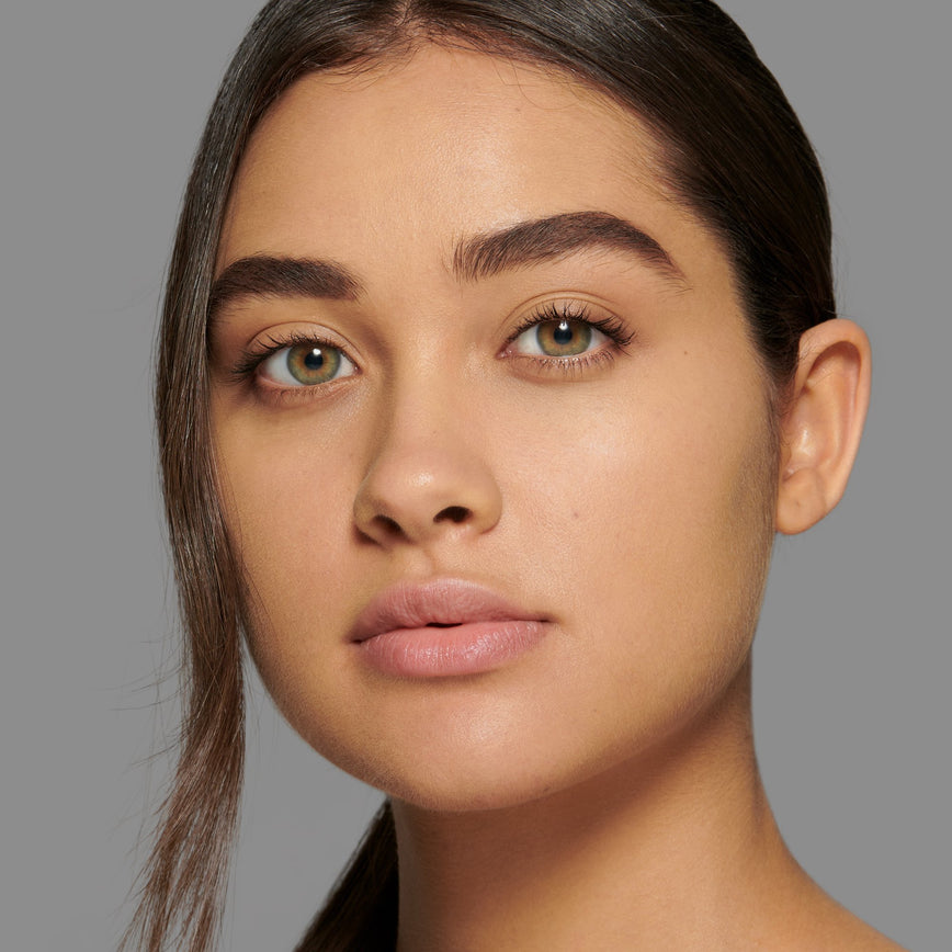 Lisa Eldridge Seamless Skin Foundation Pictured on Model. The model has light/medium skin and olive undertones, green/hazel eyes and straight, dark brown hair.