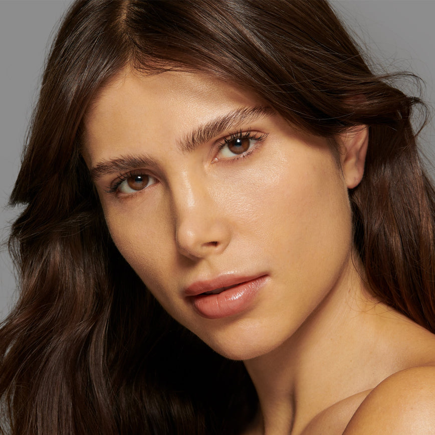 Lisa Eldridge Seamless Skin Foundation Pictured on Model. The model has light/medium skin and olive undertones, brown eyes and slightly wavy dark brown hair.